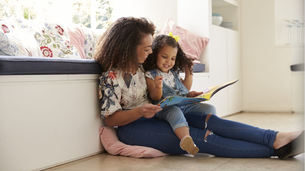 Mother reads to her young daugher