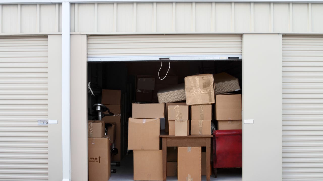A storage unit full of cardboard boxes.