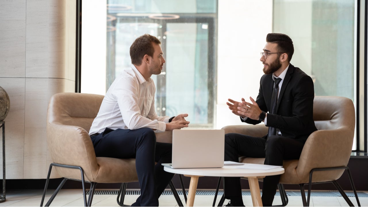 Two men discussing finances.