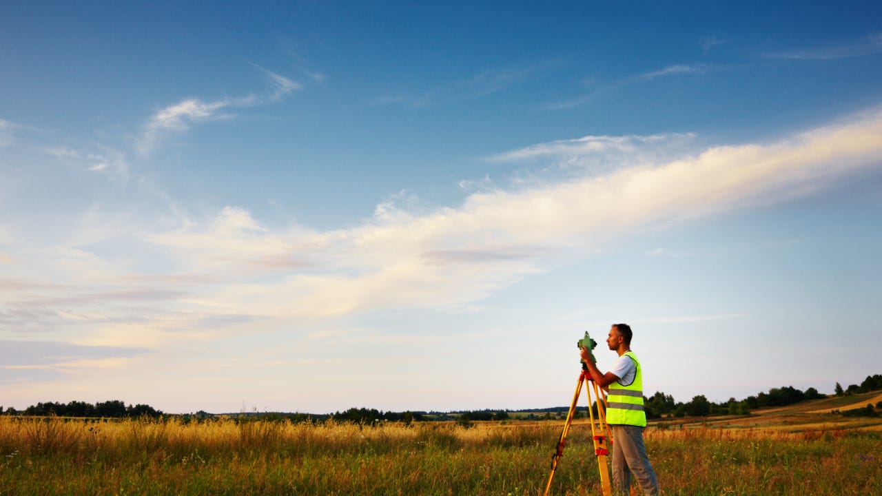 A land surveyor conducts a land survey