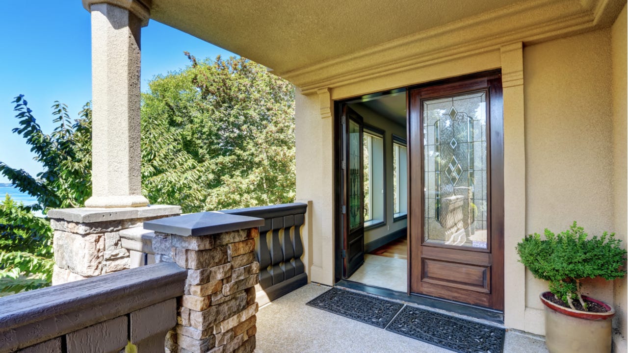 A double-door entryway with front porch and an open door
