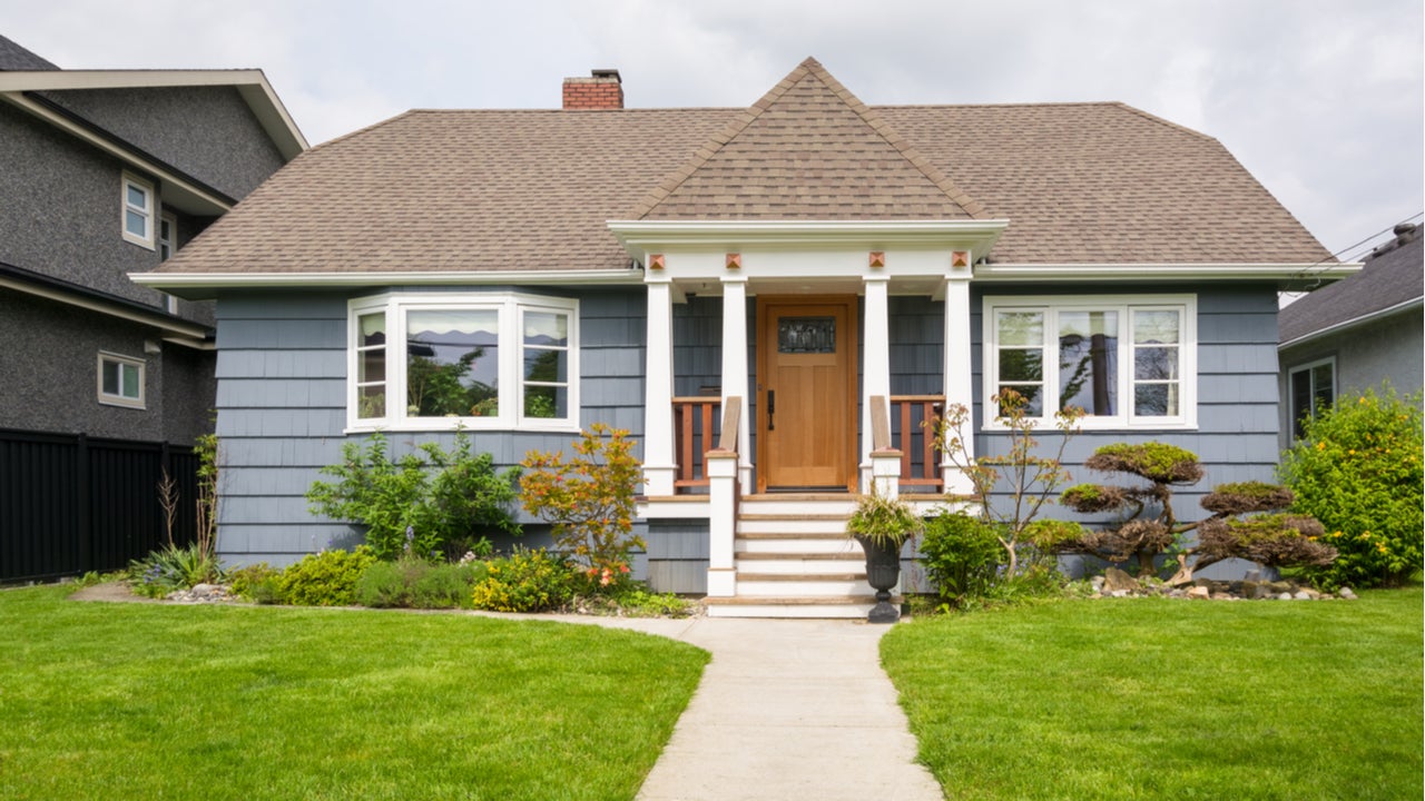 A single-story home with lawn and front path
