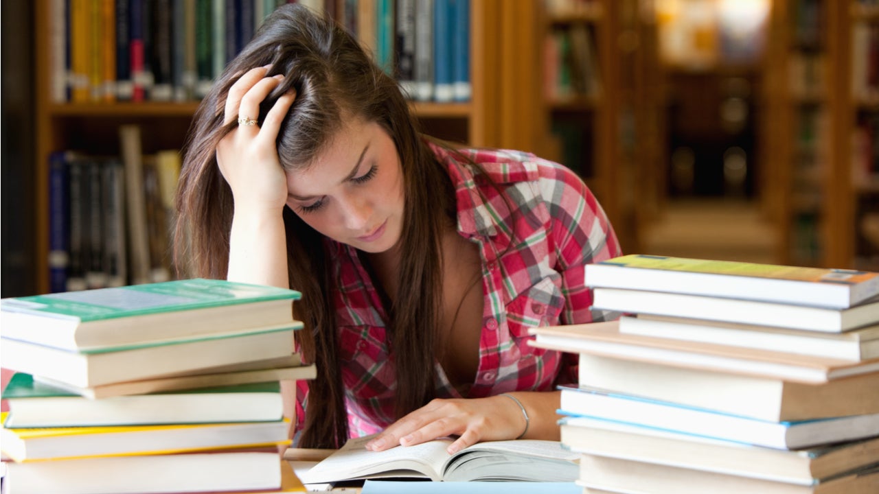 College student studies in library