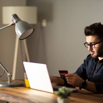 Man using credit card while online