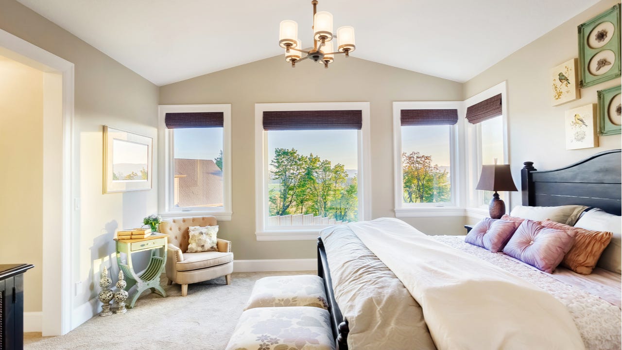 A master bedroom with view outdoors
