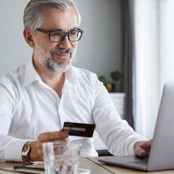 Business person holding credit card
