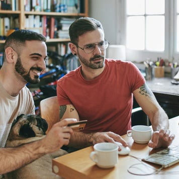 Couple sitting at computer looking at credit cards
