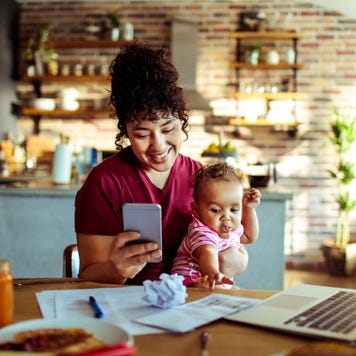 Young mother with baby and smartphone