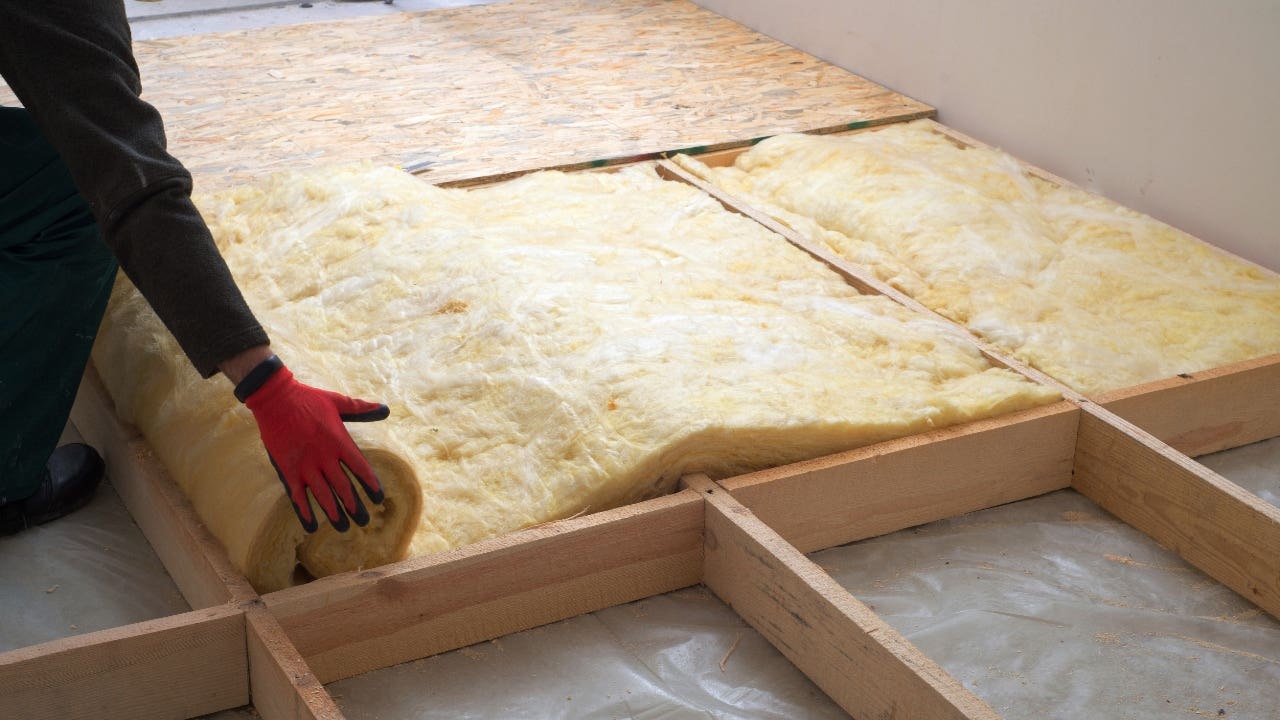 A contractor installs insulation