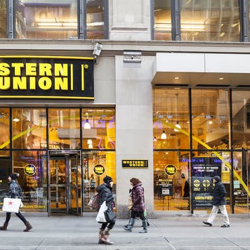 People walk by a Western Union location in New York.