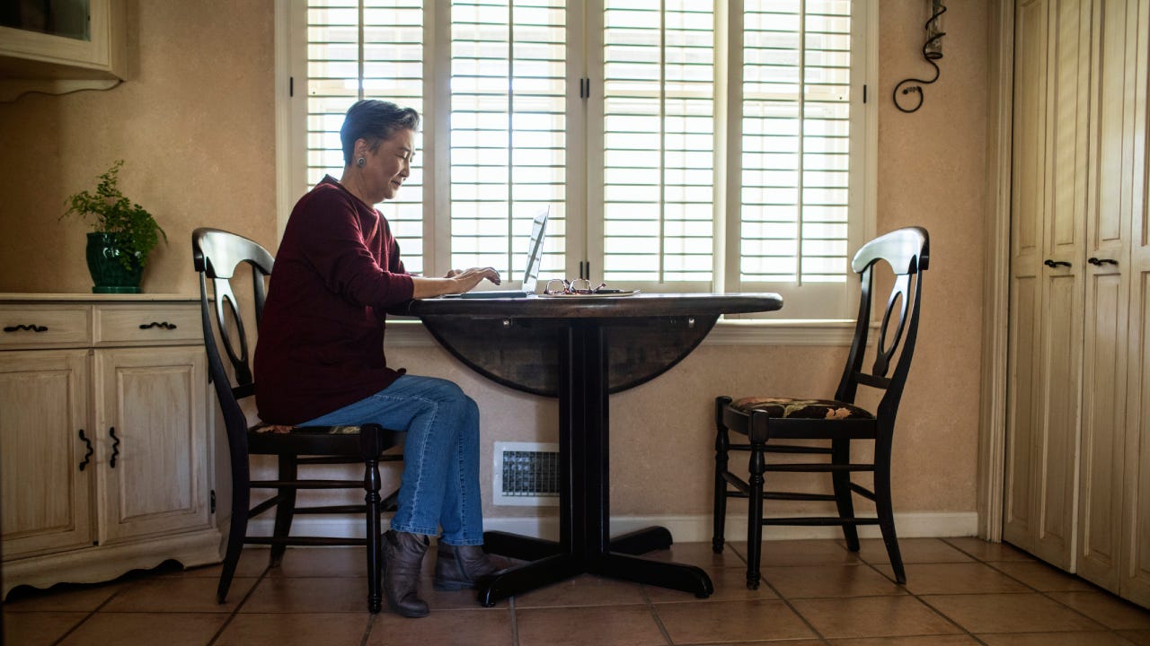 Senior woman using laptop computer at home