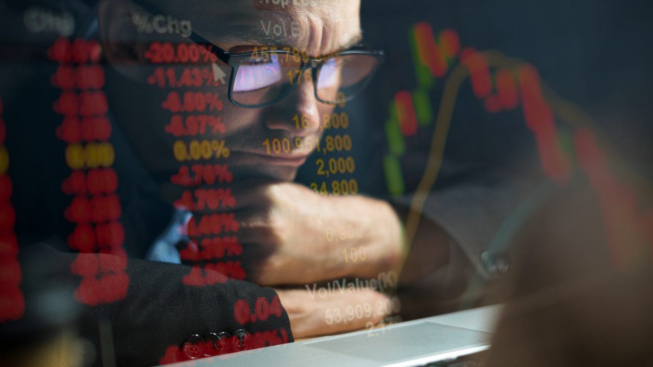 Man looks at financials on screen