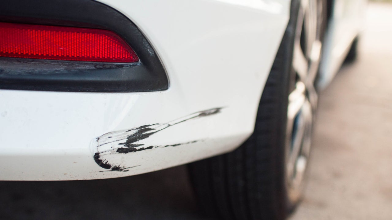 Rear car bumper with damaged paint