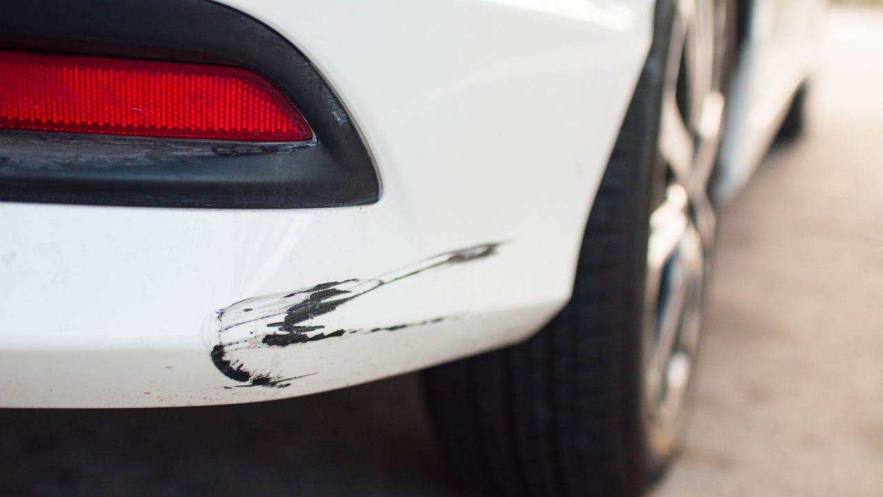 Rear car bumper with damaged paint