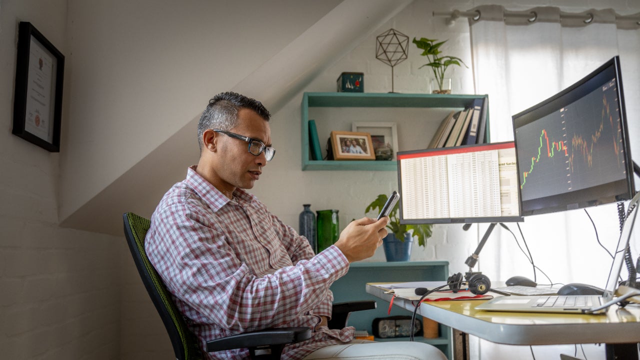 A man trades options from his desk at home