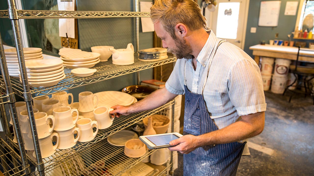 pottery studio owner taking inventory