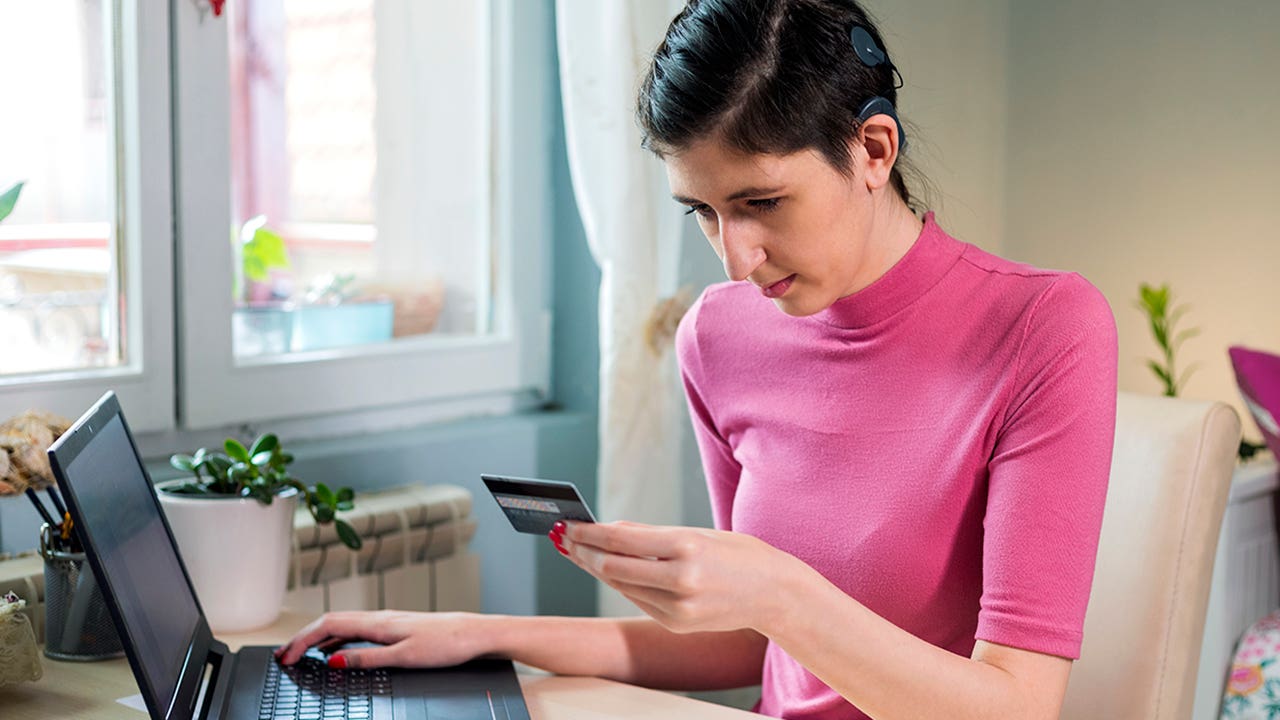 woman with cochlear implant using laptop at home