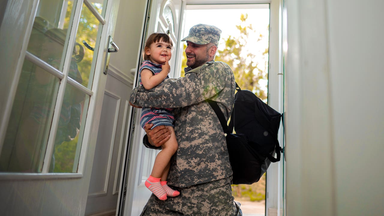 military father hugging his daughter when arriving home