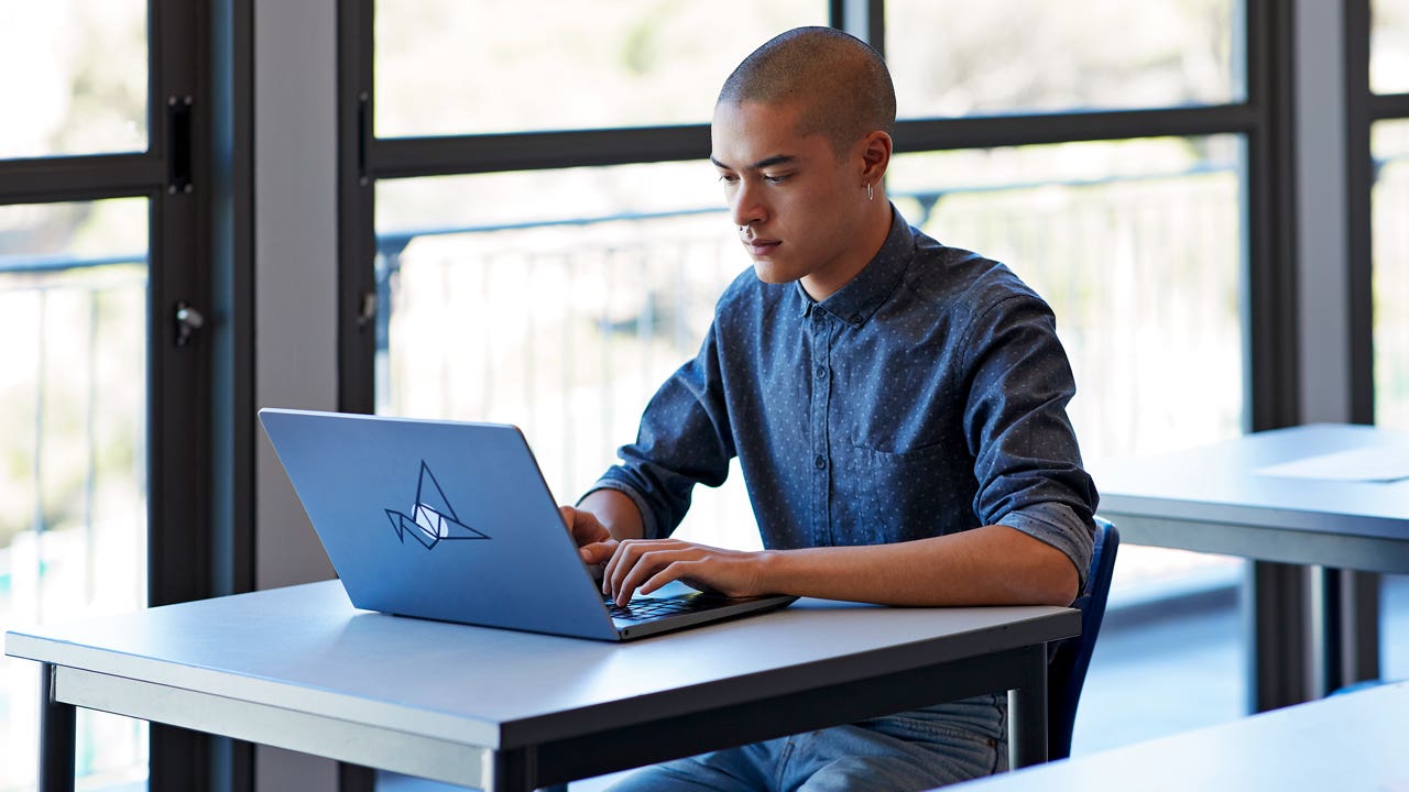 student working on his laptop