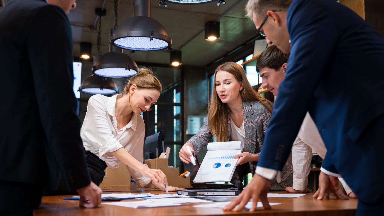 An investment club of men and women meets in an office