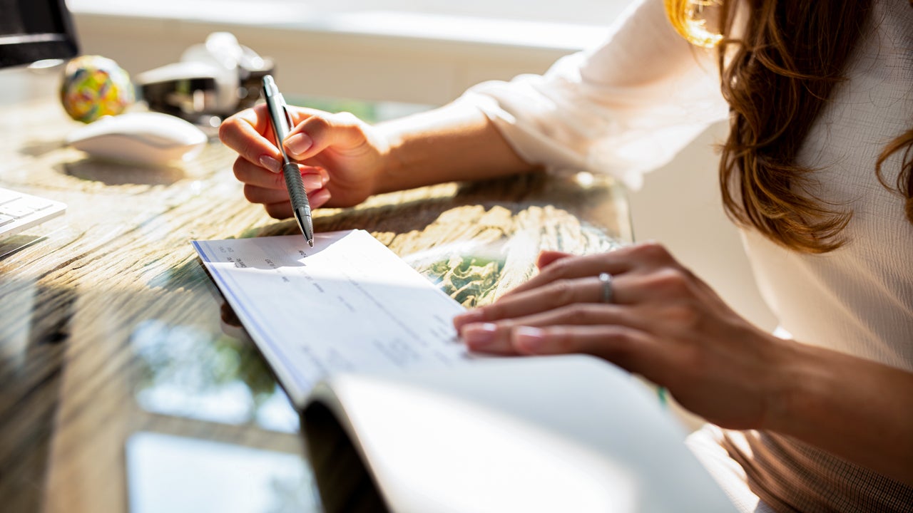 person signing a check