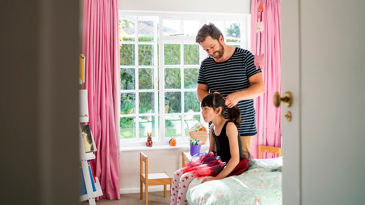 father doing daughters hair