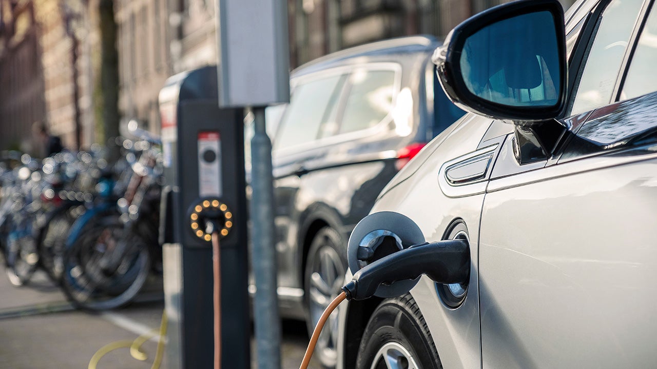 Charging an electric car in public station by the street, The Netherlands