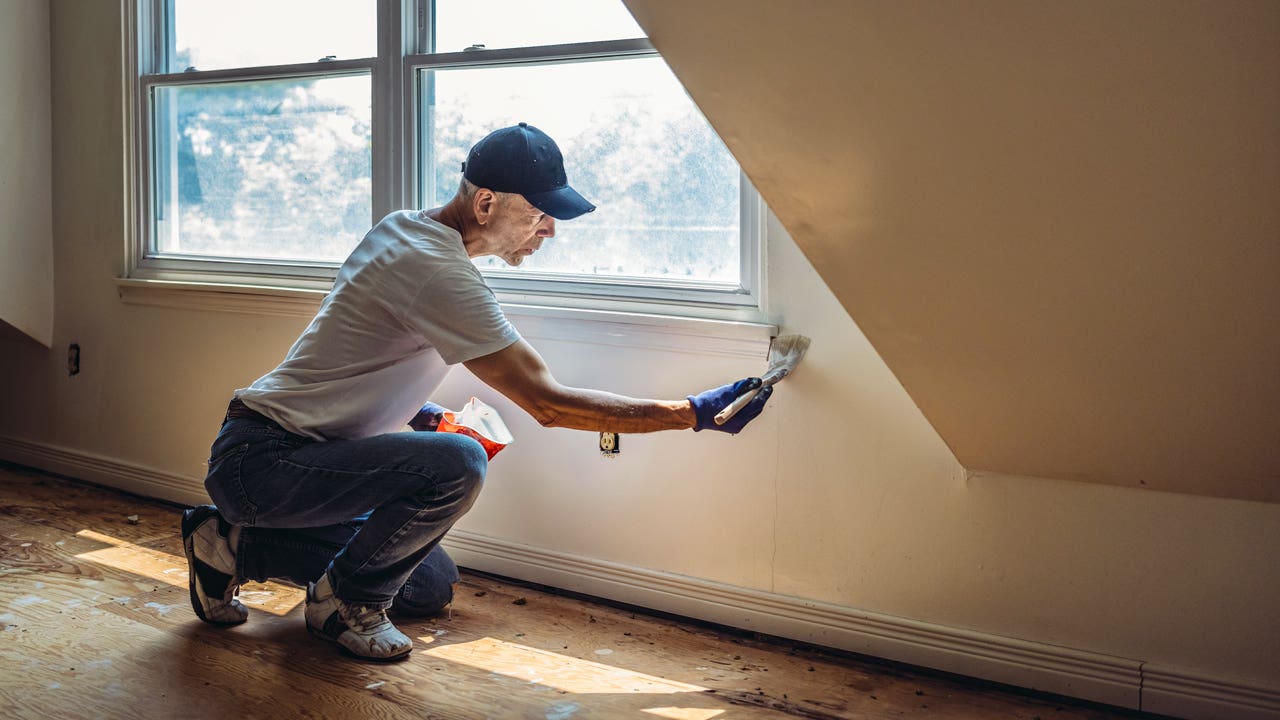 man painting a wall
