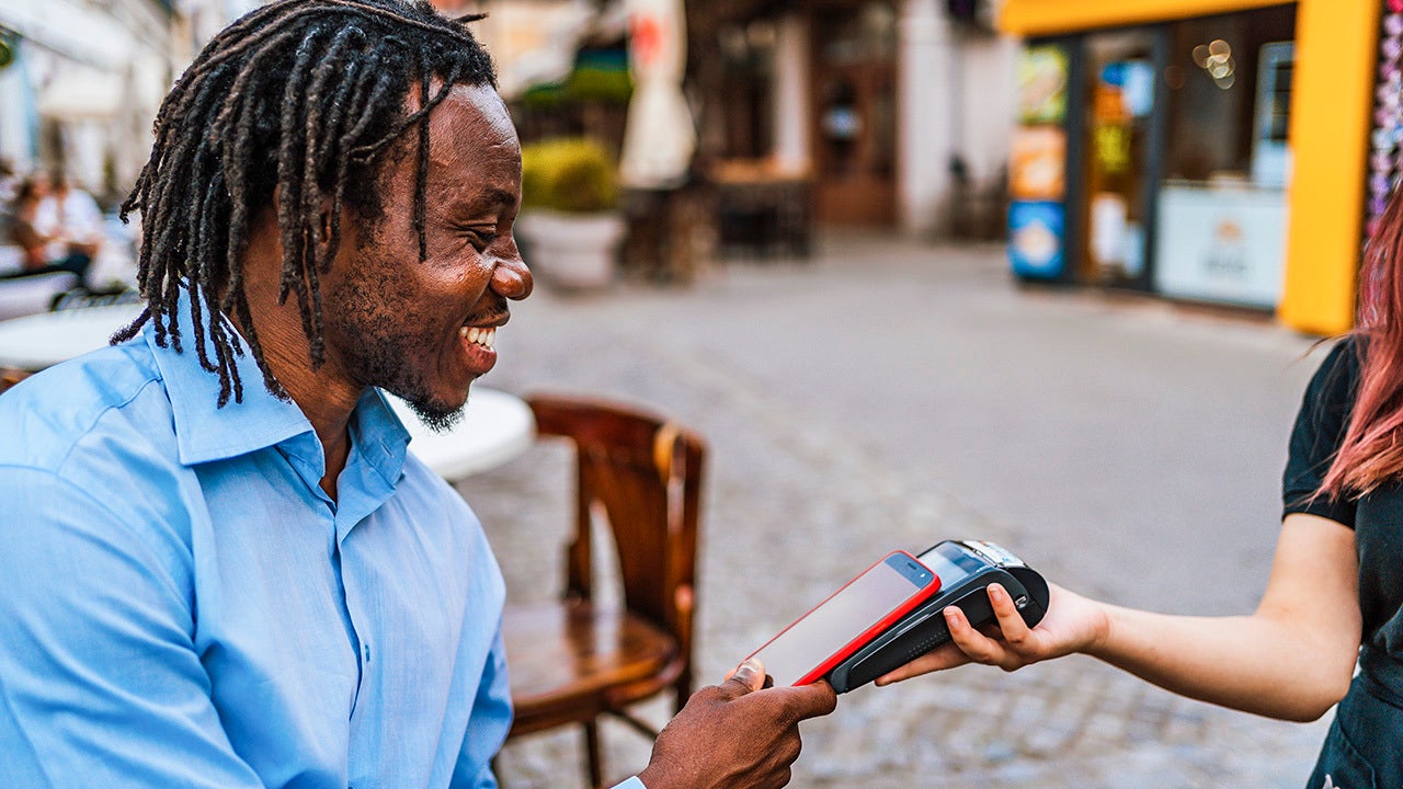 Man paying courier via smartphone