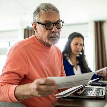 Senior couple payings bills inside home