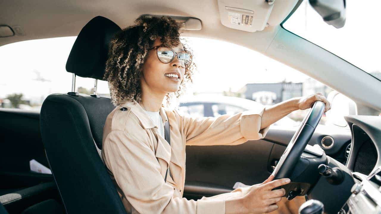 Young woman driving car