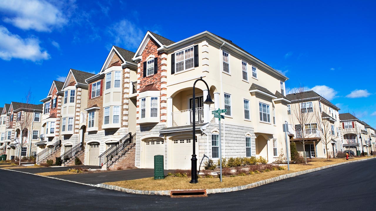 deed restricted property - suburban row houses with blue sky