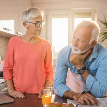 senior couple spending time together but apart during a breakfast in a morning