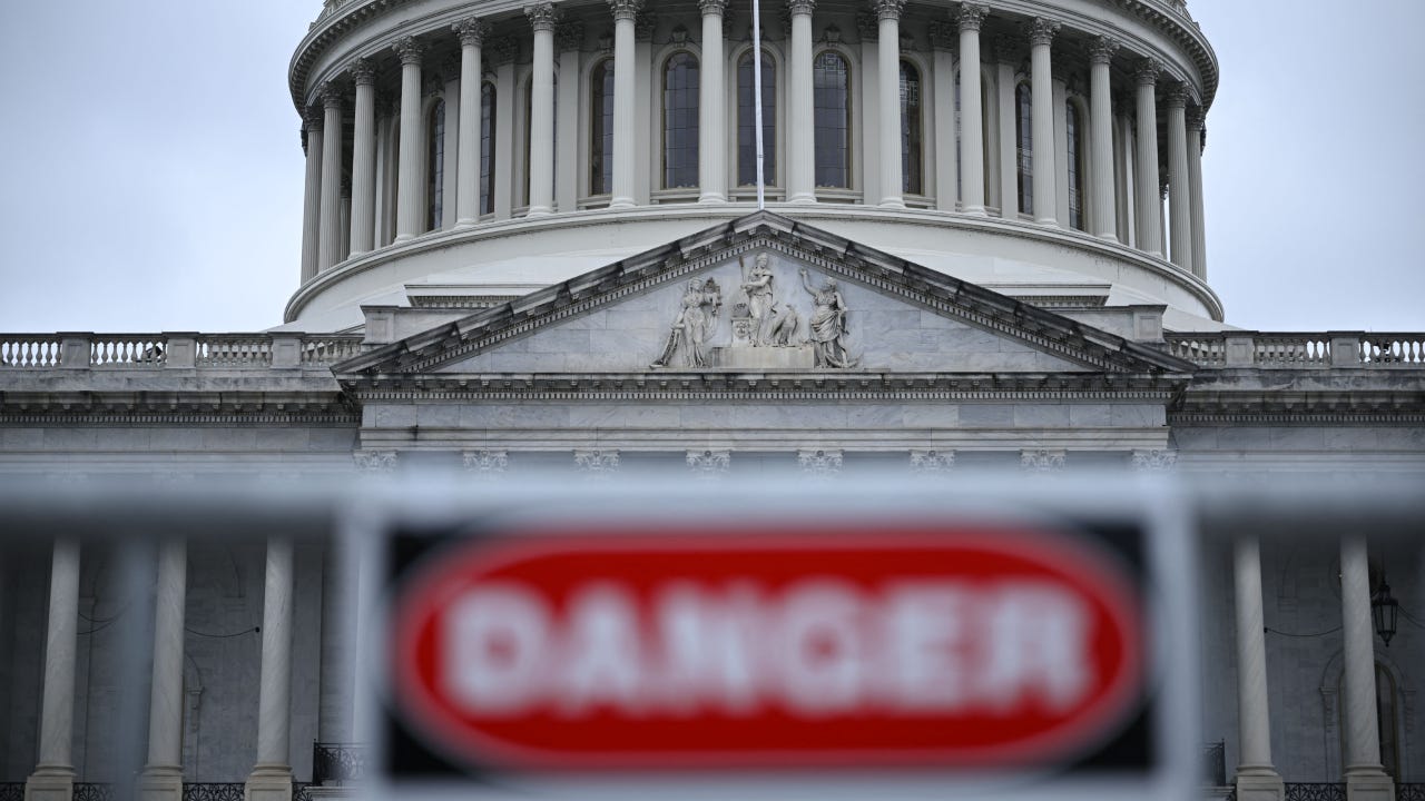 U.S. capital building with a blurry DANGER sign in front