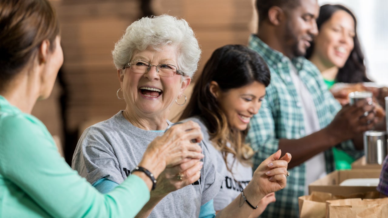 cheerful senior woman volunteers at food bank
