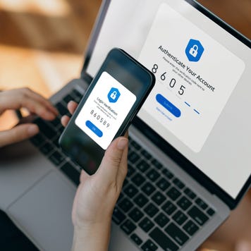 Cropped hand of woman using mobile device with Two-Factor Authentication