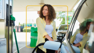 Woman pumps gas into her car. There are federal and state excise taxes on gasoline.
