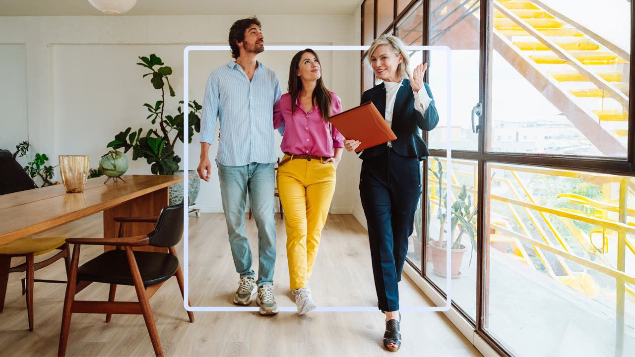 a couple touring a home with a professional real estate broker
