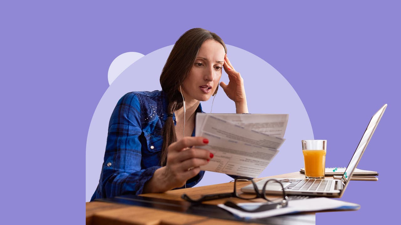 Person studying various checks, money