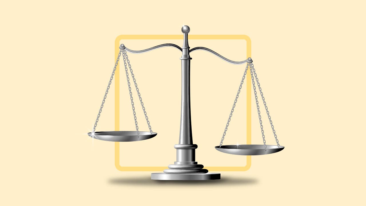 balancing scales on a pale yellow background
