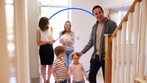 realtor showing a family (mom, dad, kids) a new house