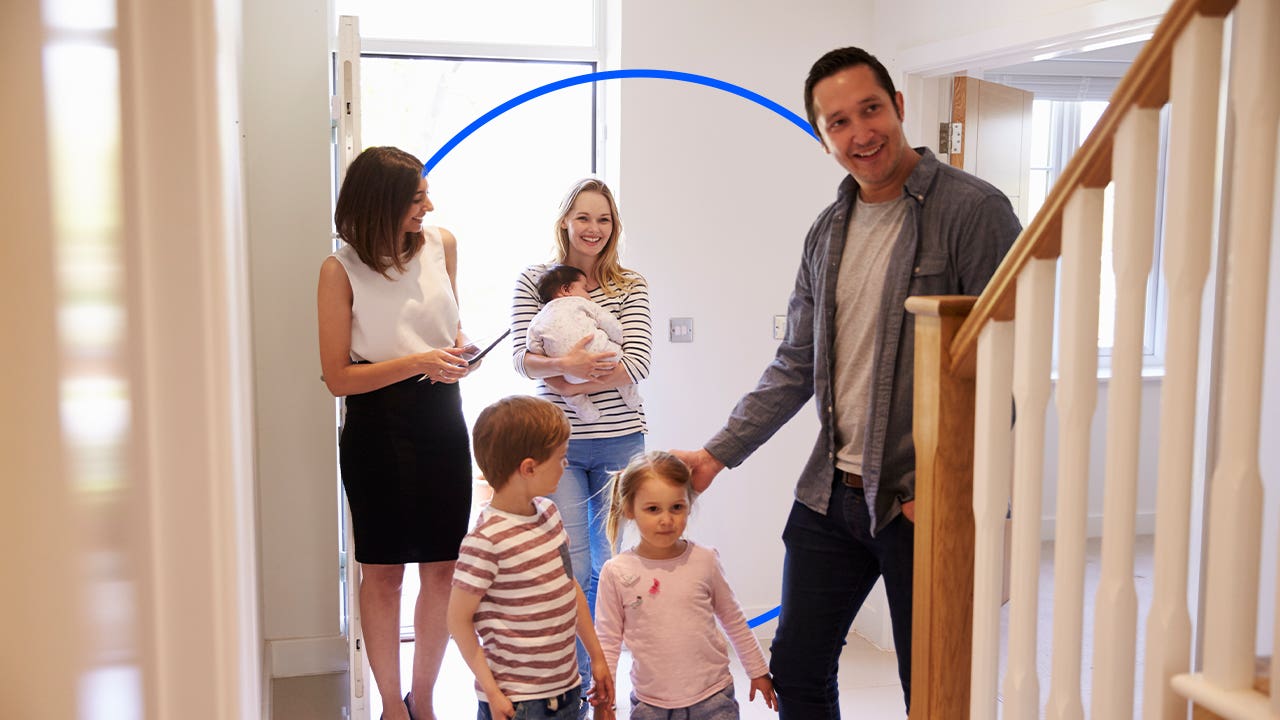 realtor showing a family (mom, dad, kids) a new house