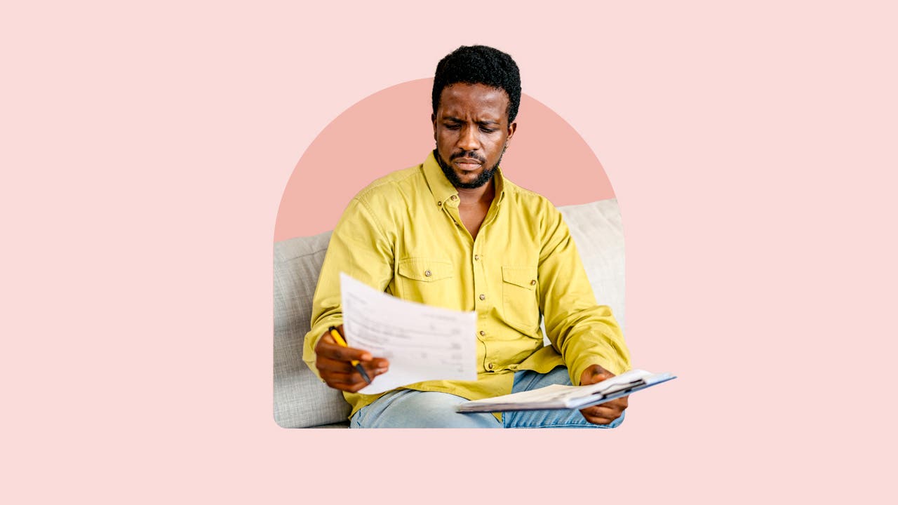 A black man looks at paperwork.
