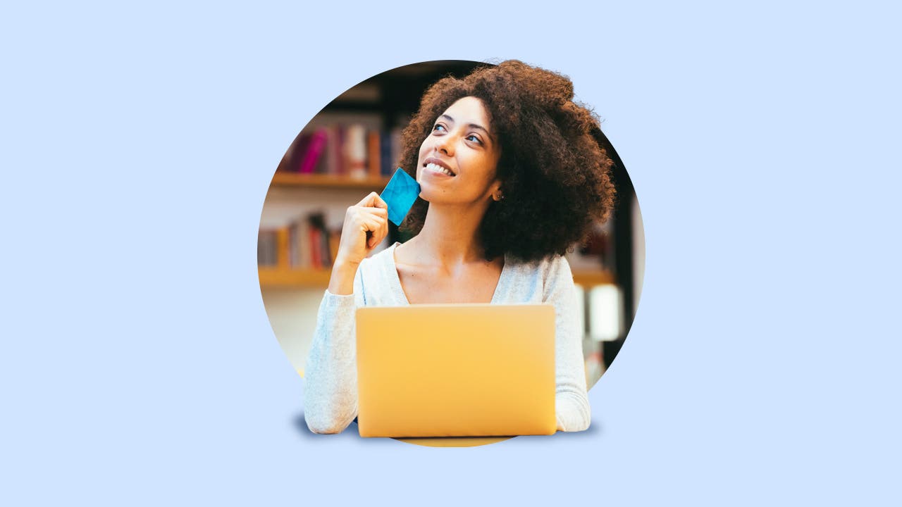 design image of a young women on her laptop holding a credit card in her hand