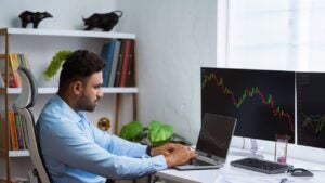 A trader looks at a graph on his computer showing market volatility.