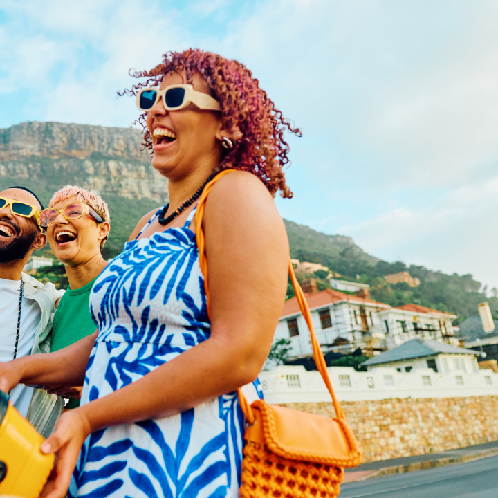 Three happy friends capture a cheerful moment with a selfie during their travel adventure