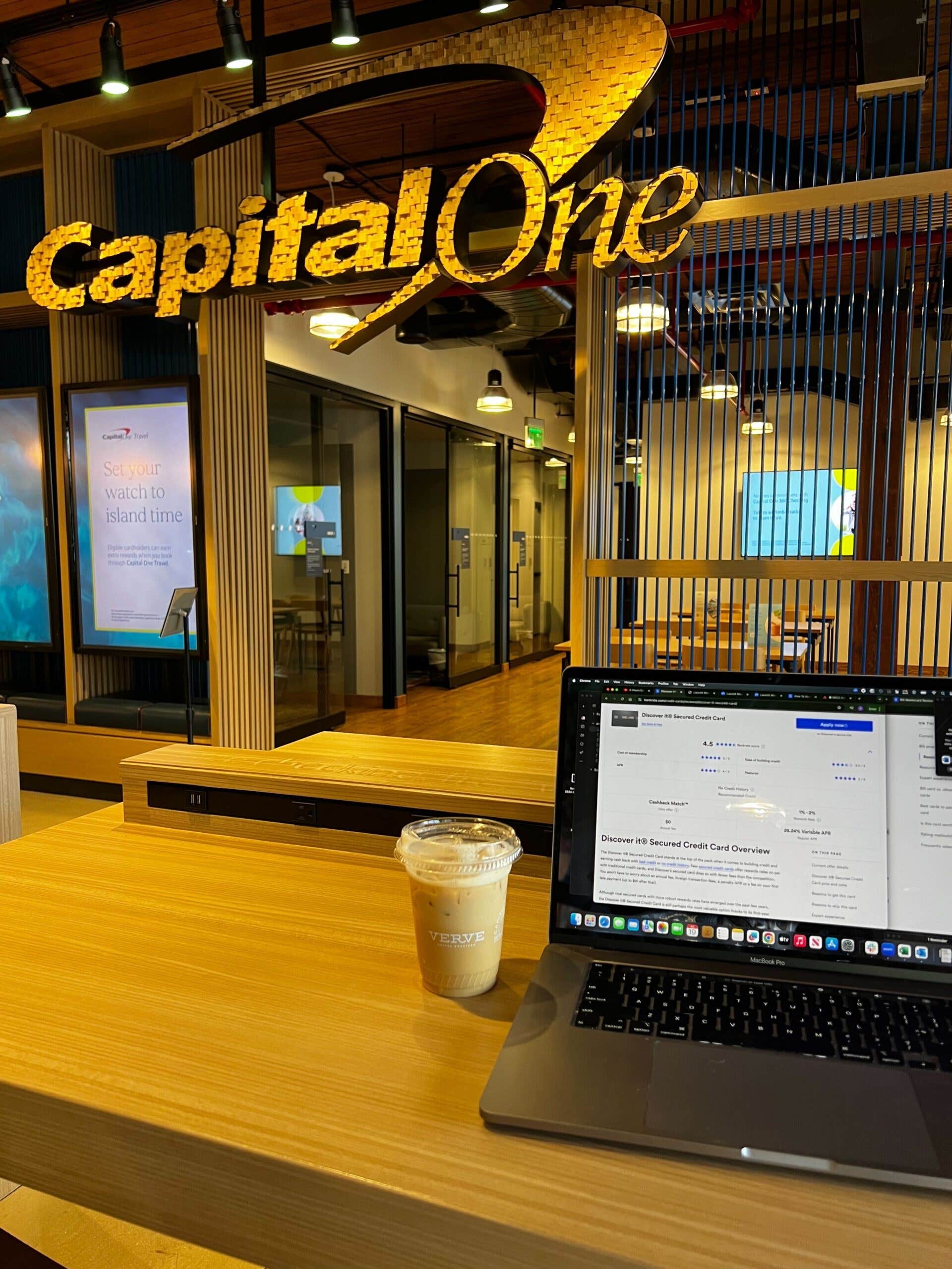 Coffee cup sitting next to laptop on desk