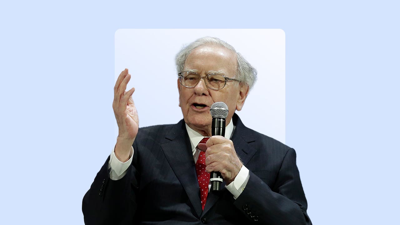 Warren Buffett holding a microphone.