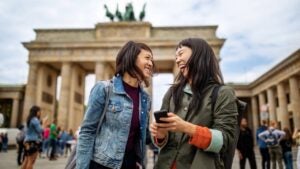 Cheerful friends standing against Brandenburg Gate