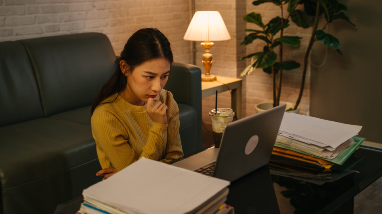 Serious woman working on laptop.